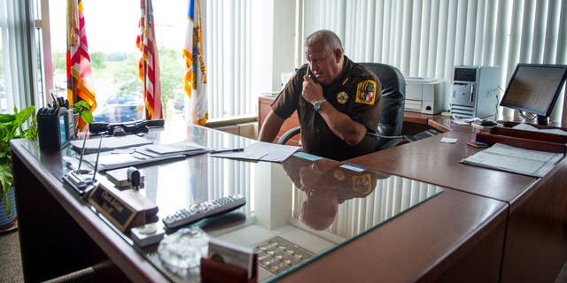 Frederick County Sheriff Charles Jenkins takes a phone call while working in his office at the Frederick County Law Enforcement Center July 23, 2013, in Frederick, Md.