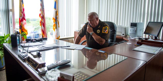 Frederick County Sheriff Charles Jenkins takes a phone call while working in his office at the Frederick County Law Enforcement Center July 23, 2013, in Frederick, Md.