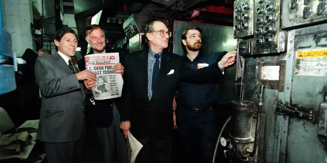 Martin Singerman (second from right) is seen with the first issue of the Sunday Post in 1996.