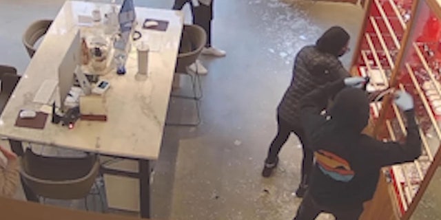 footage showing suspects grabbing eyewear from display