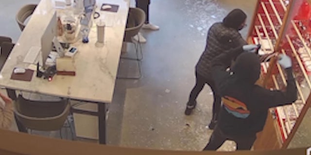 footage showing suspects grabbing eyewear from display