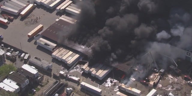 Black smoke over warehouse