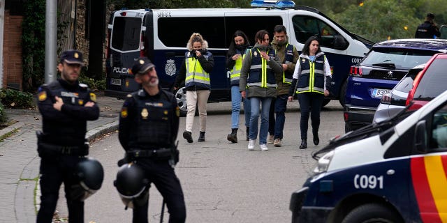 Police officers surround the Ukrainian embassy in Madrid, Spain, on Nov. 30, 2022, following reports of a blast at the embassy. A 74-year-old man was charged with terrorism for sending explosive letters to high-profile diplomatic figures.