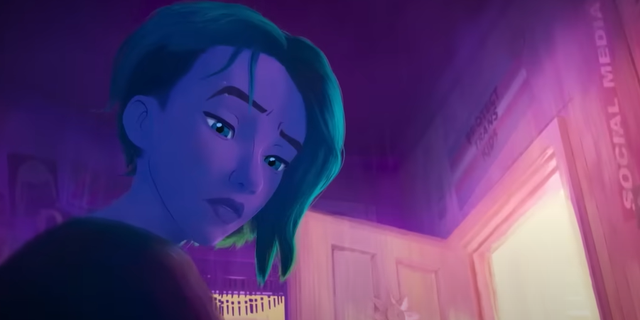 Screencap from "Spider-Man: Across the Spider-Verse Trailer #2," posted on the "Entertainment Tonight" YouTube channel. A poster or flag saying "PROTECT TRANS KIDS" can be seen above the doorway,