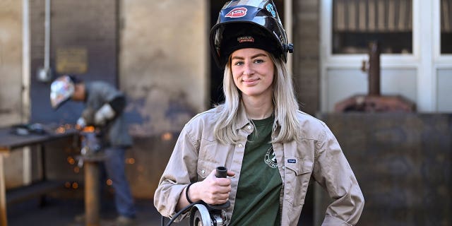 Tennessee College of Applied Technology Nashville student Abbey Carlson poses during a welding class on April 13, 2023, in Nashville, Tennessee. Trade schools in Tennessee are booming despite a state program that made community college free since 2015.