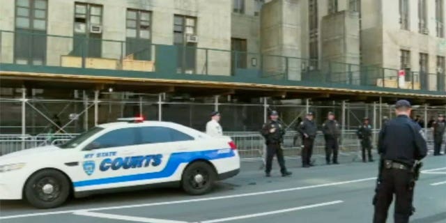 Cops line up outside of Manhattan court ahead of Trump arraignment.