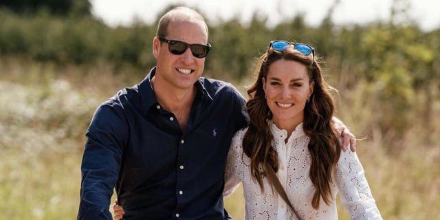 will and kate smiling while riding bicycles in the countryside