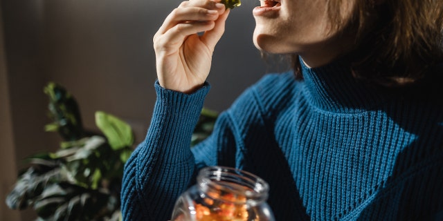 Woman taking gummies