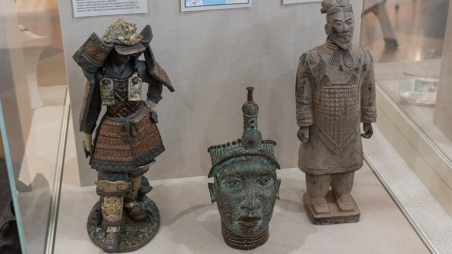 Three statues from Asia on display at Unclaimed Baggage Museum.