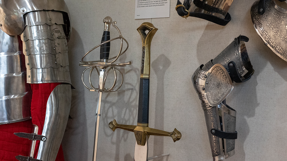 Close up view of suit of armor, swords and protective gear at Unclaimed Baggage Museum.