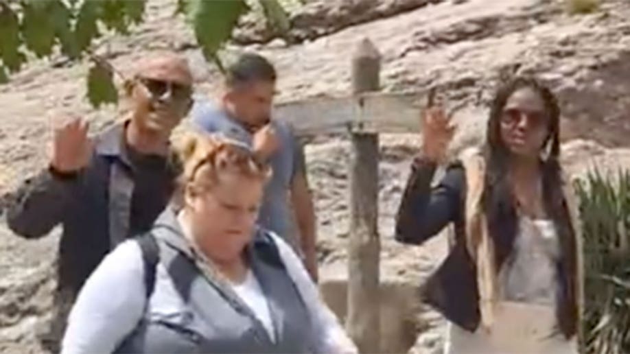 Barack and Michelle Obama wave at tourists in Spain