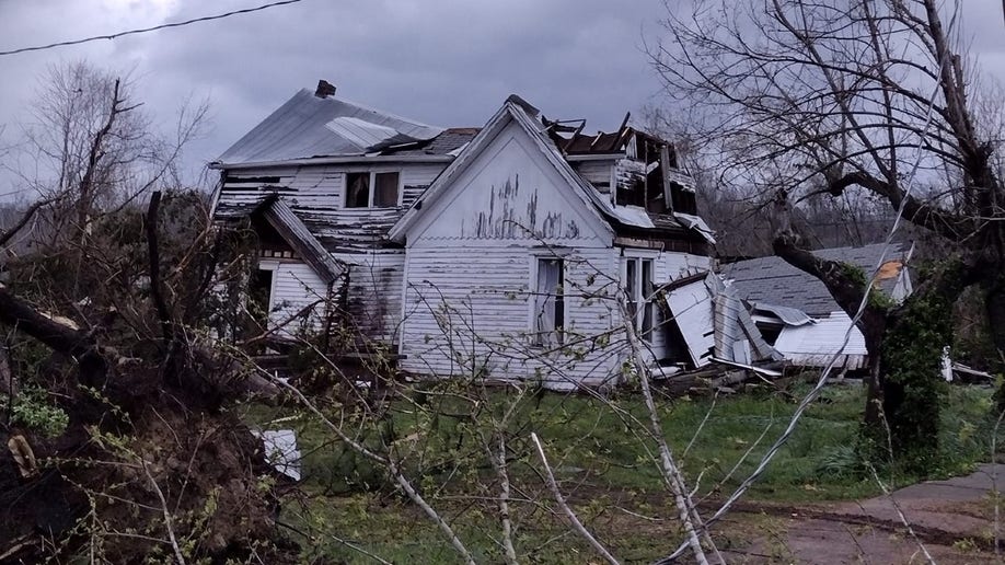 A white house is damaged from the Missouri tornado