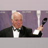 Seymour Stein holding his award after being inducted into the rock and roll hall of fame