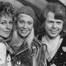 Black and white photo of ABBA members from (L-R) Benny Andersson, Anni-Frid Lyngstad, Agnetha Fältskog and Björn Ulvaeus inset a black and white photo of Lasse Wellander playing guitar