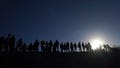 Migrants stand on the Mexican side of the U.S.-Mexico border, on the banks of the Rio Grande, in Ciudad Juarez, Mexico, on March 29, 2023.