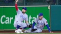 Chicago Cubs' Seiya Suzuki, left, signals to the dugout as Chicago Cubs center fielder Cody Bellinger (24) is slow to get up after catching a fly ball by Houston Astros' Kyle Tucker during the seventh inning of a baseball game Monday, May 15, 2023, in Houston.
