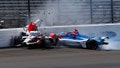 Katherine Legge, of England, left, and Stefan Wilson, of England, crash in the first turn during practice for the Indianapolis 500 auto race at Indianapolis Motor Speedway in Indianapolis, Tuesday, May 23, 2023.