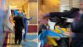 The Ukrainian delegate is seen punching the Russian official after his photobomb attempt was disrupted.