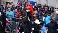 A rider loses control of their horse as crowds gather to watch the coronation procession of Britain's King Charles III and Queen Camilla, in London, Saturday, May 6, 2023. (Christopher Pledger/Pool via AP)