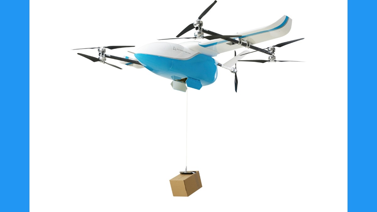 Photo of a drone carrying a box.