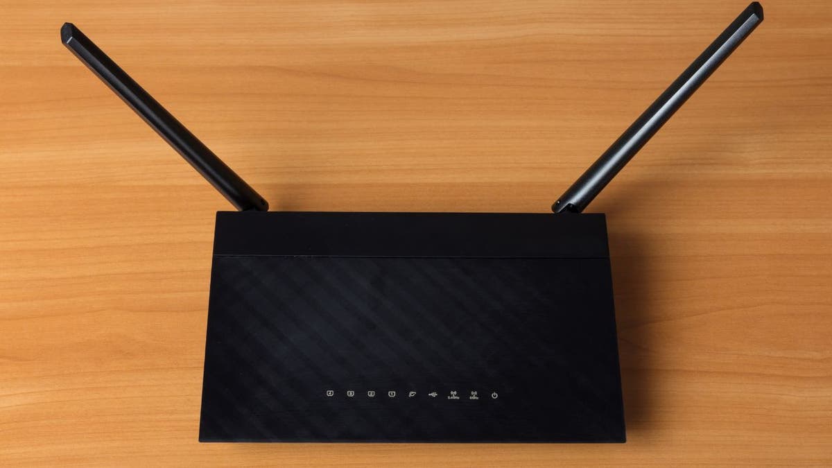 Black wifi router on a wooden desk 