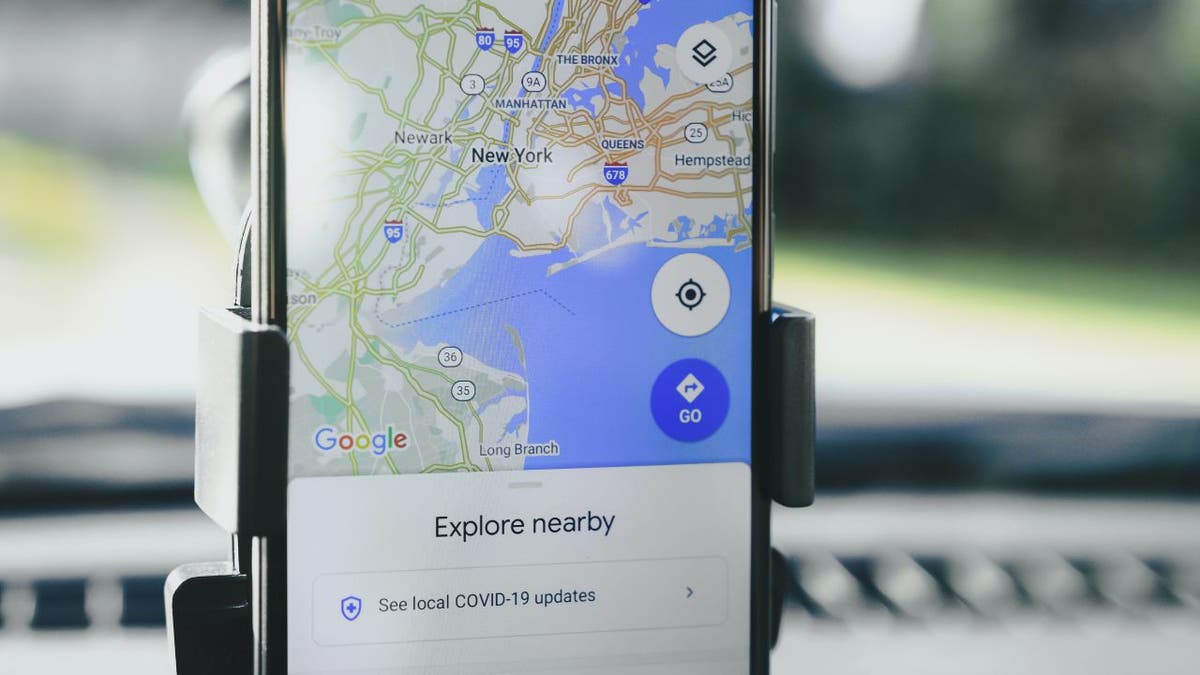 Image of Google Maps pulled up and opened on phone sitting in phone holder in a car