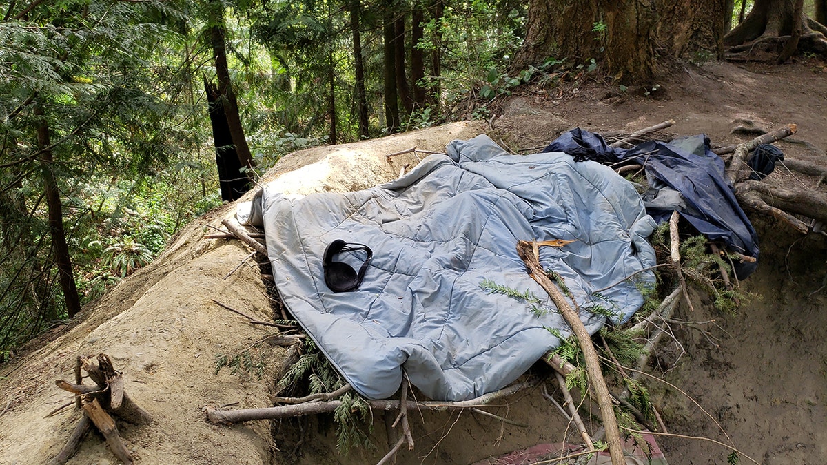 Black bra on a light blue blanket on the ground