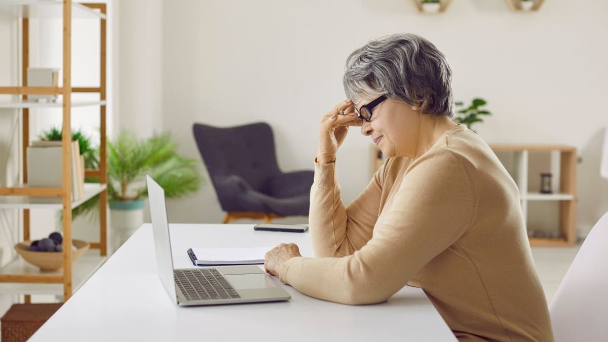 Frustrated woman works on computer