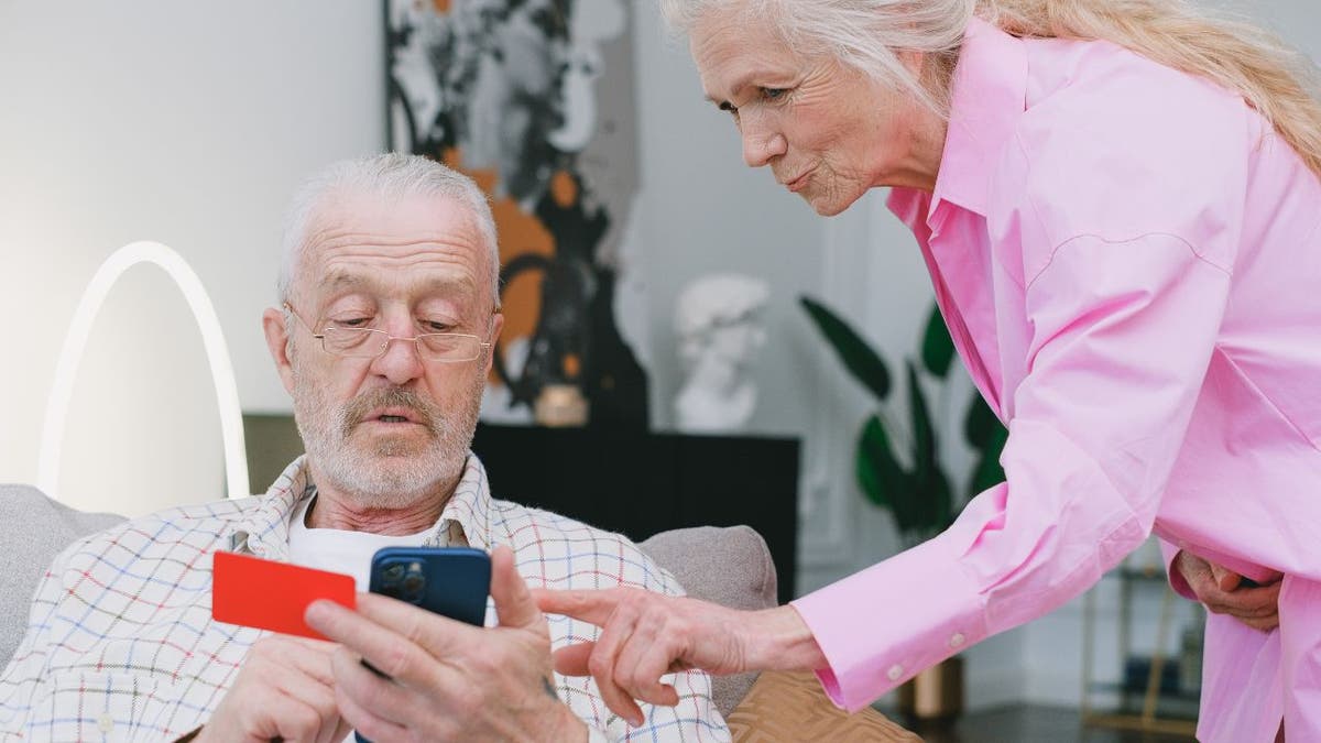 Old couple looks at iphone