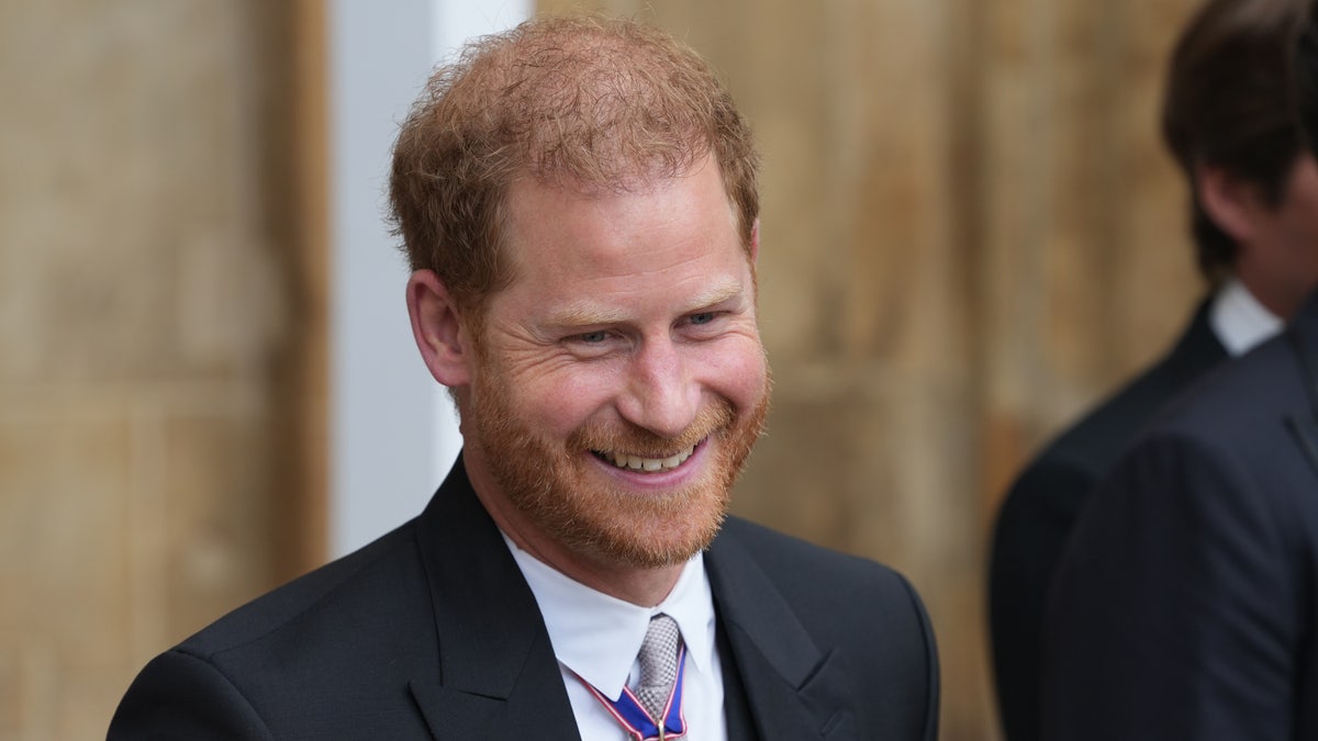 Prince Harry smiles in a <a href=