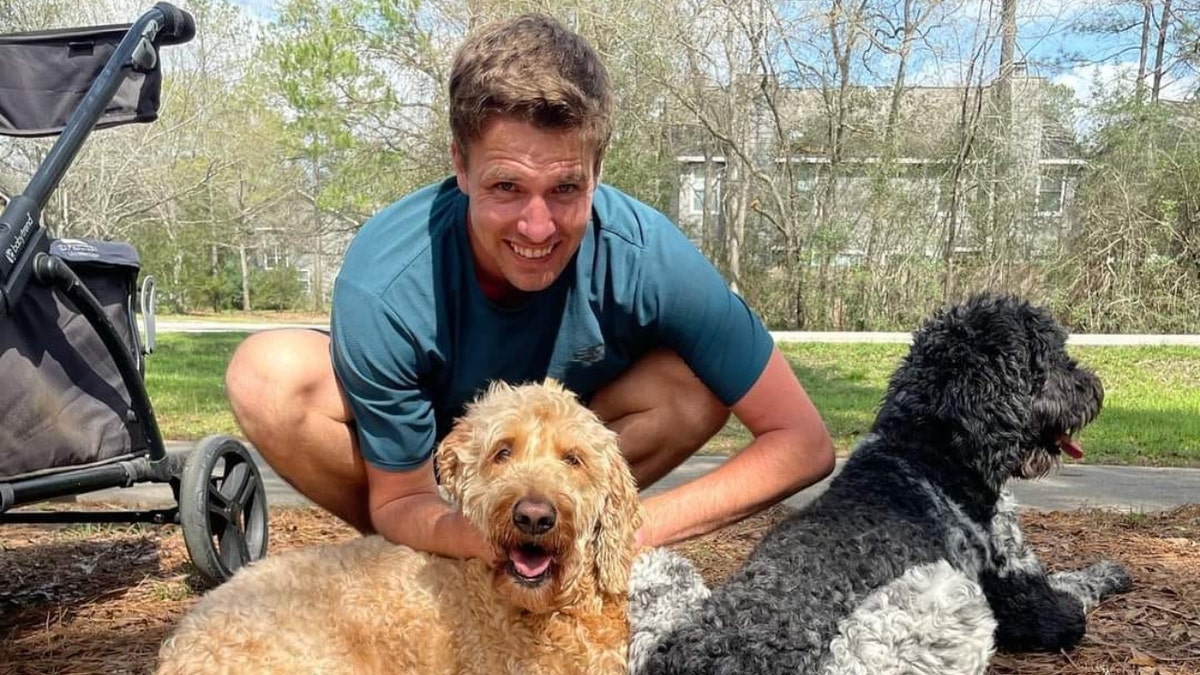 Colby Richards poses with his dogs outside