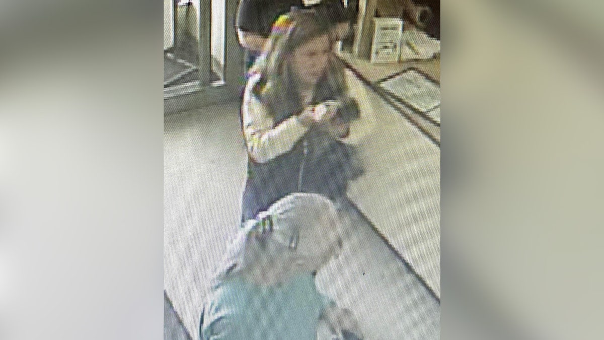 Women holding raccoon