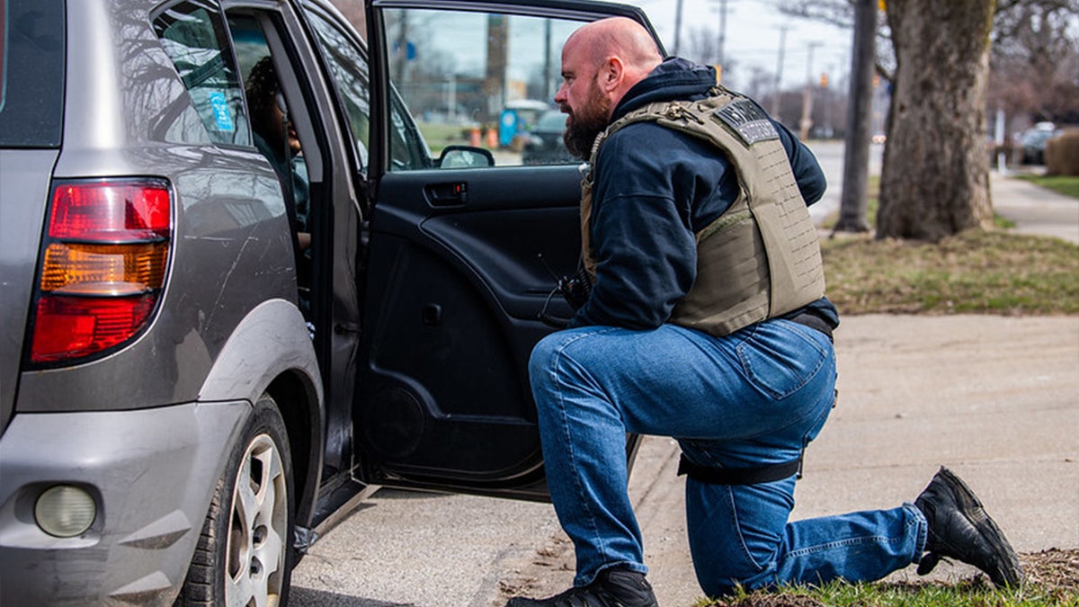 U.S. Marshal speaks with child