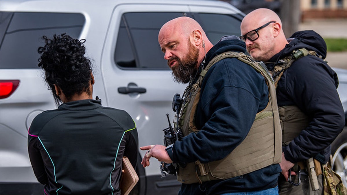 U.S. Marshal speaks with woman