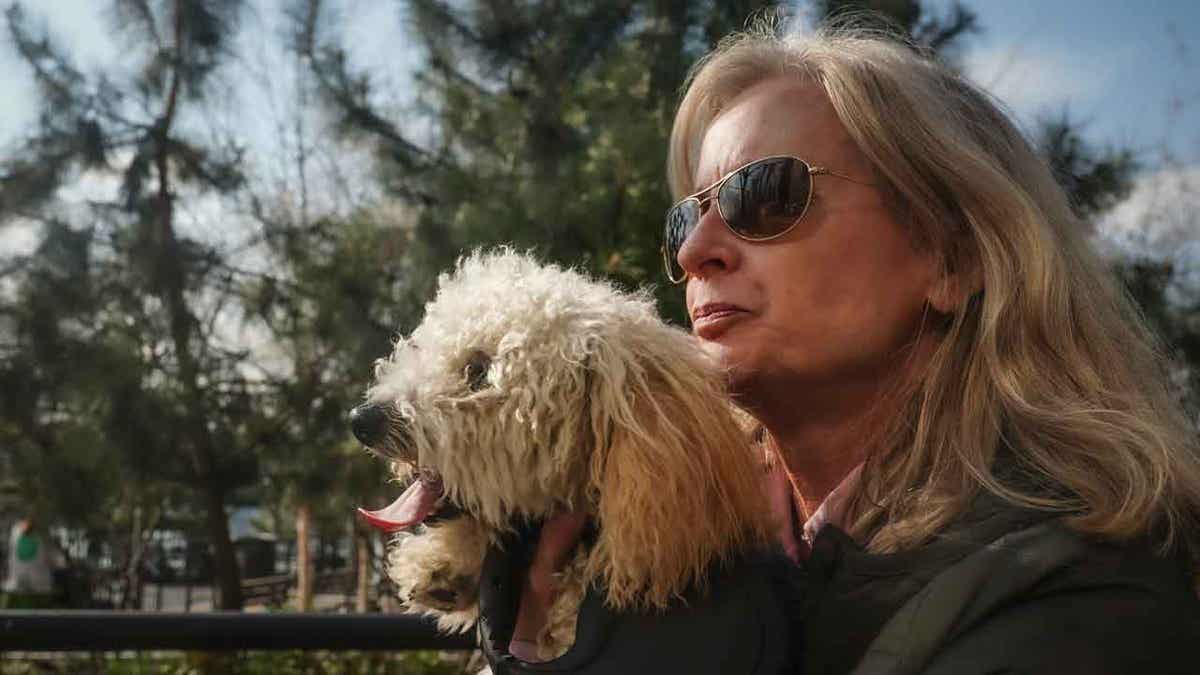 Colleen Briggs holds her 8-month-old poodle named Bondi