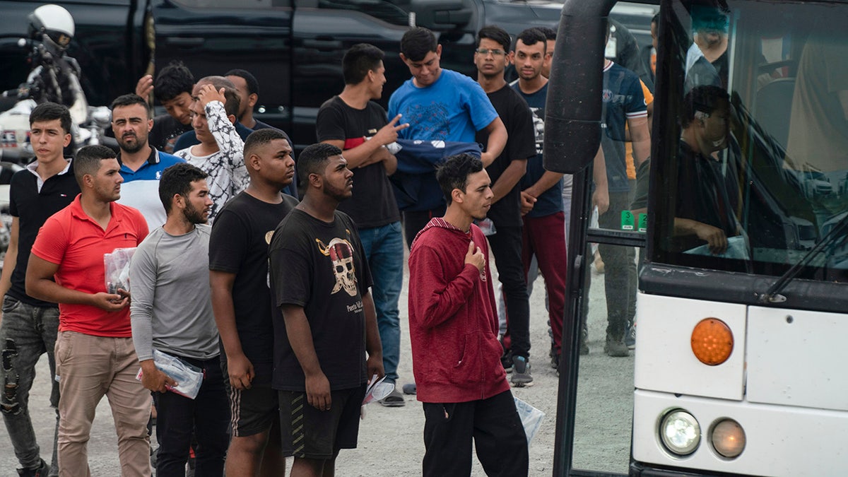 Migrants board bus in Texas