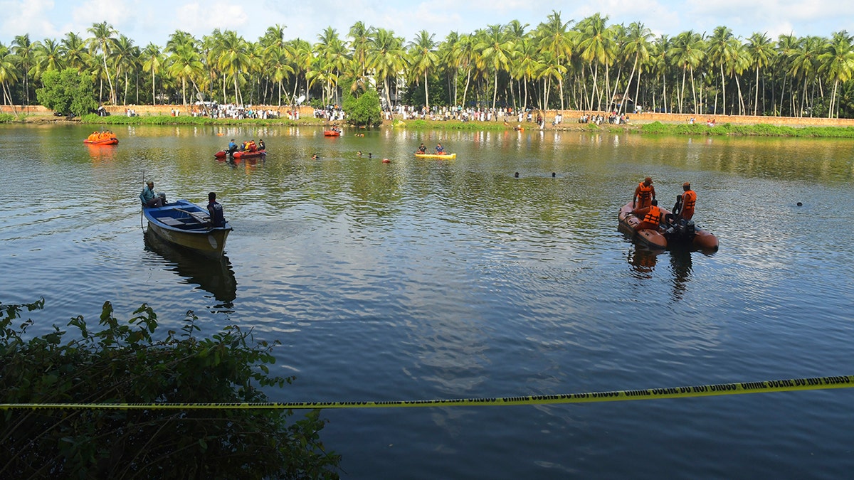People in small boats searching for victims in water
