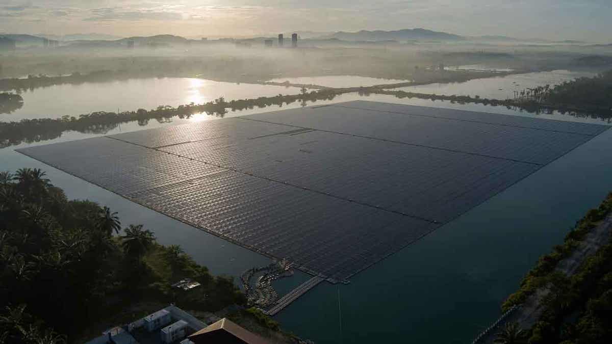 The sun rises over floating solar panels