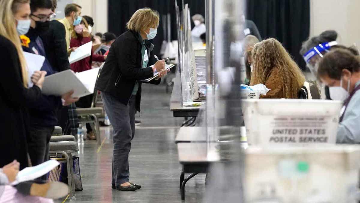 Recount observers watch ballots during a Milwaukee 