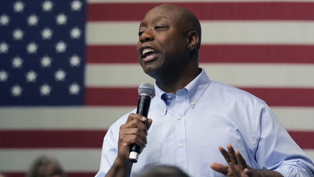 Tim Scott speaking in front of an American flag