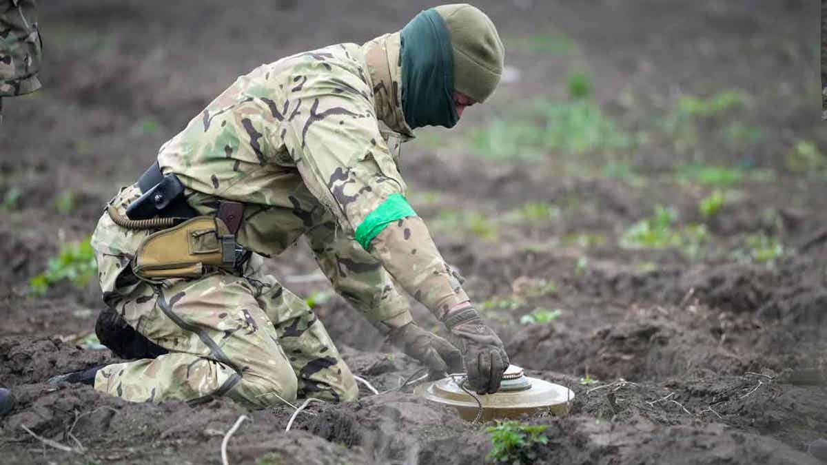 An interior ministry sapper defuses a mine