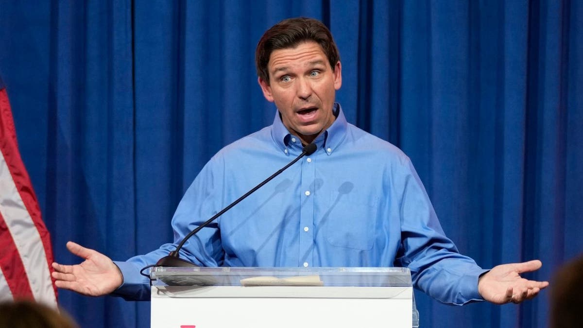 Ron DeSantis speaking at lectern in Iowa