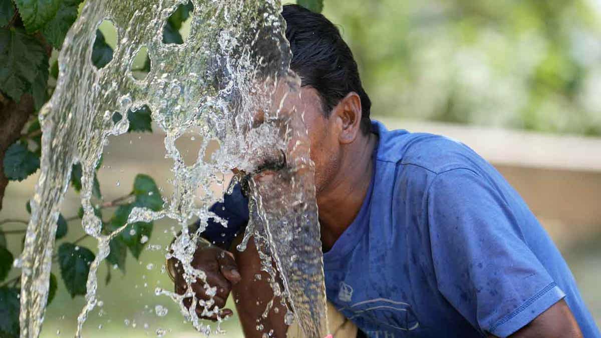 Person spraying water on his face