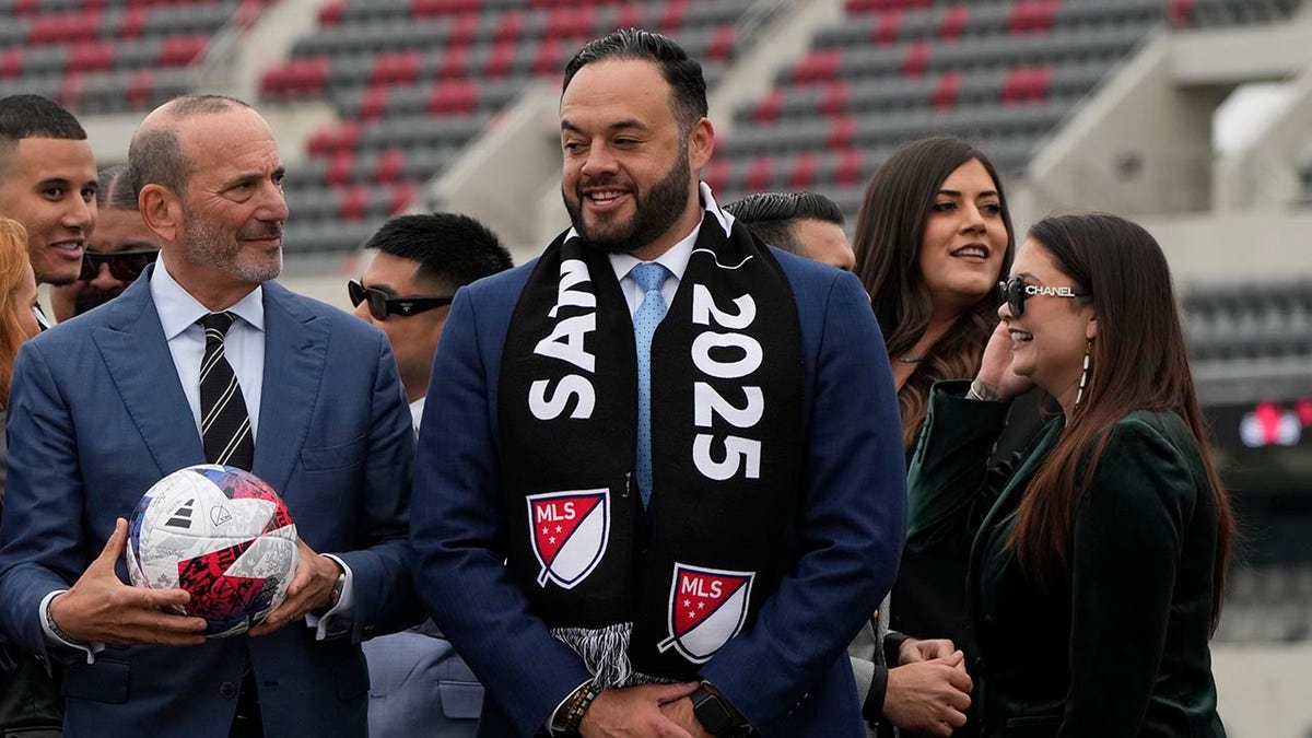 Major League Soccer Commissioner Don Garber stands with the ownership of the new MLS team