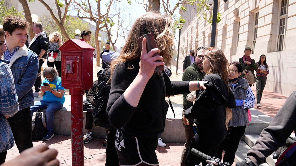 Woman with brick at San Francisco meeting