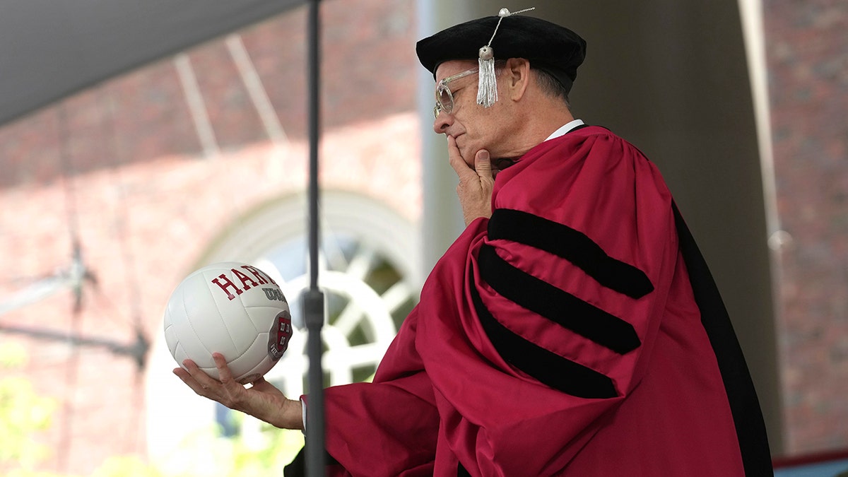 Hanks holding a volleyball