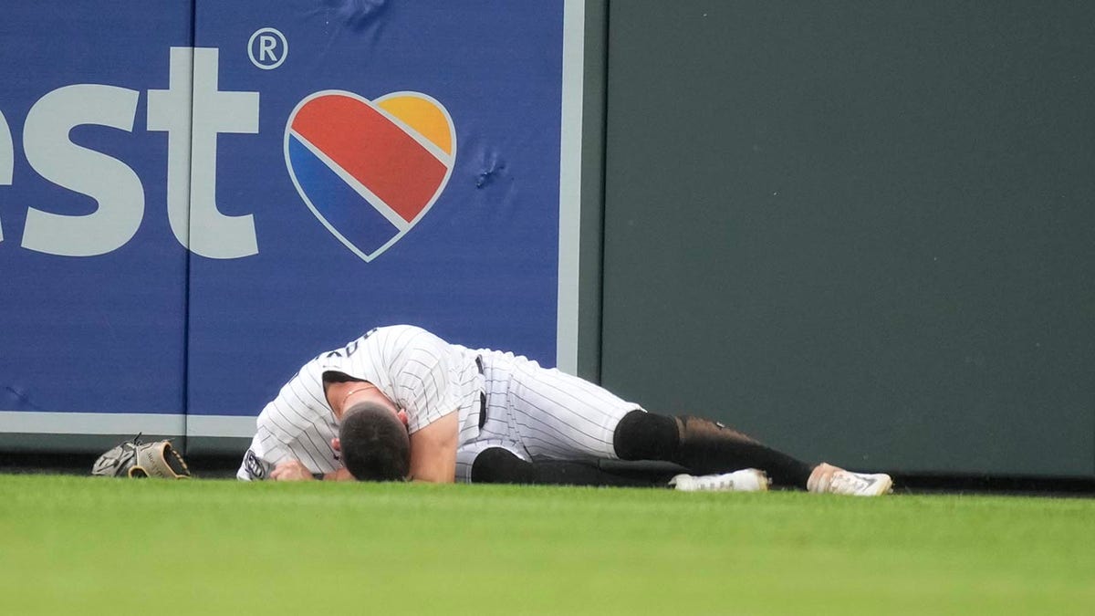 Brenton Doyle lays on the ground in pain