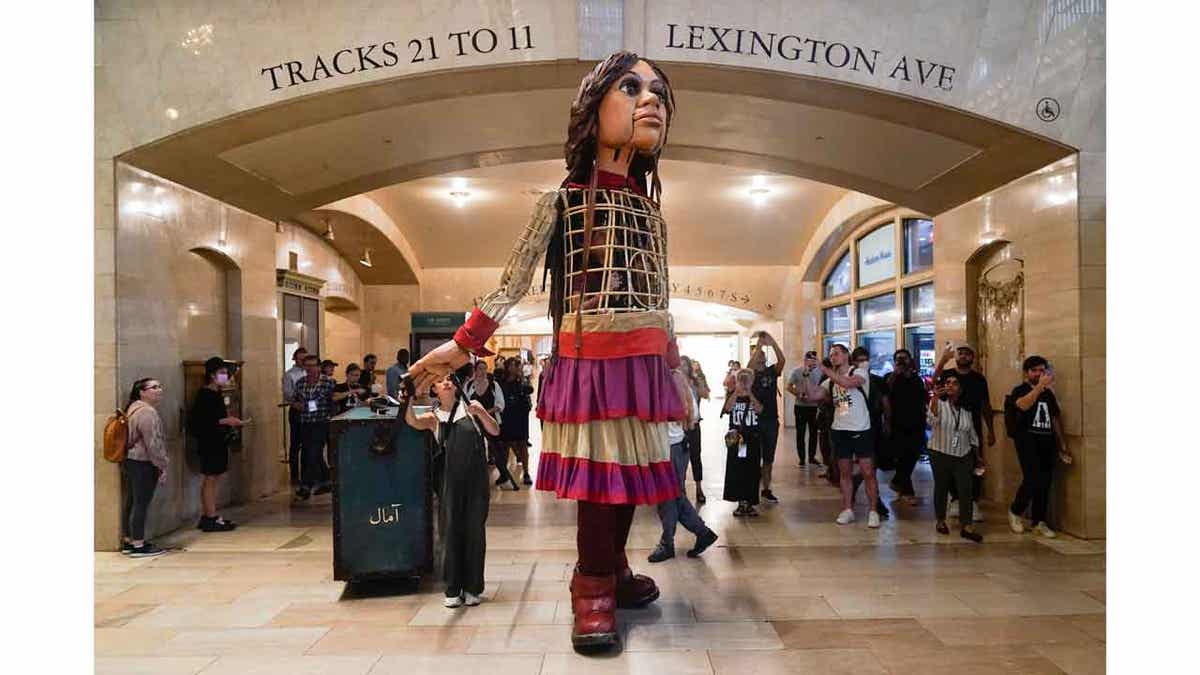 A 12-foot puppet of a 10-year-old Syrian refuge