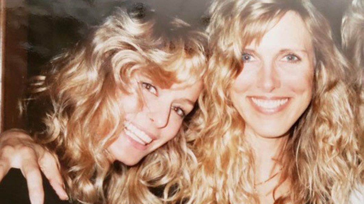 A close-up of Farrah Fawcett smiling and leaning into Alana Stewart