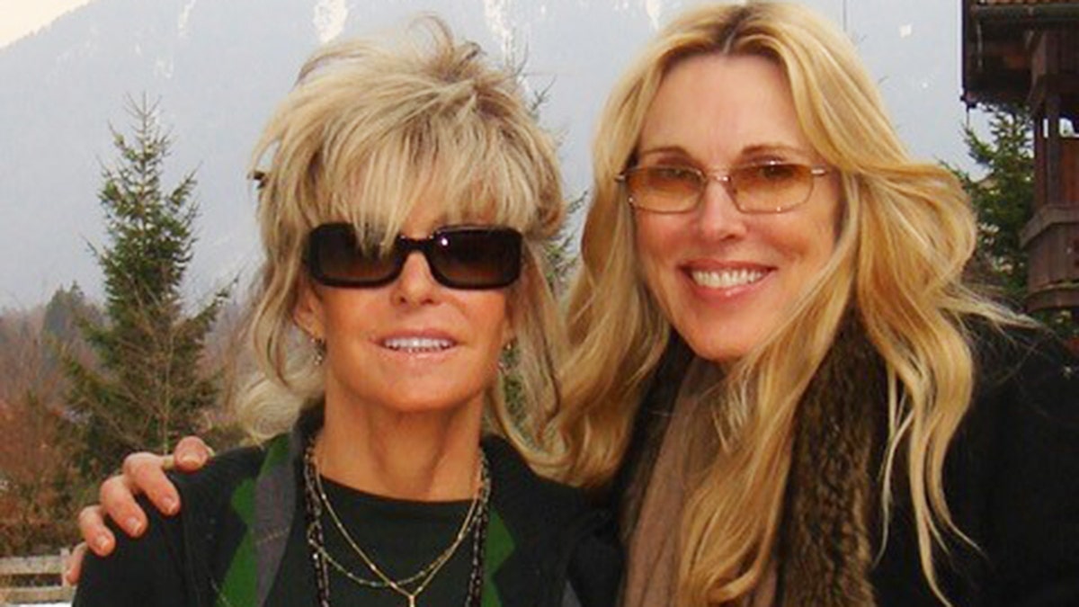 Farrah Fawcett and Alana Stewart wearing black while Farrah Fawcett wears black sunglasses
